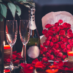 red-roses-two-glasses-bottle-champagne-candle-table